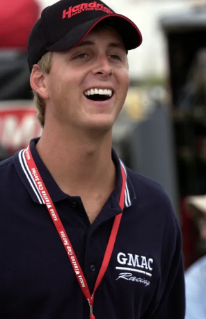 Ricky Hendrick posing in his racing firesuit